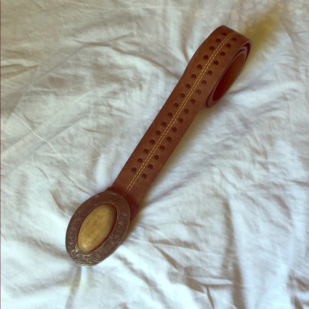 Brown belt with wood/metal belt buckle. One size.